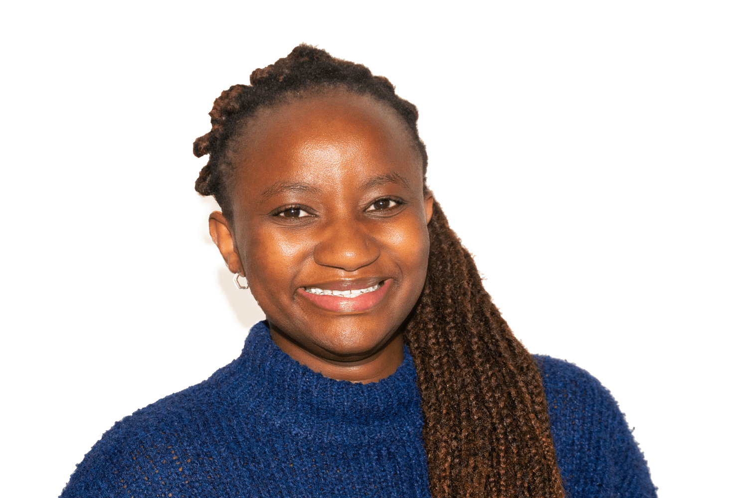 Carol has long dark hair, worn in braids. She is wearing a navy blue turtleneck. 